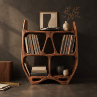 Corner detail of turntable stand shaped like a sculpted open shelf unit with two pointed tips beside wood, brass and linen samples