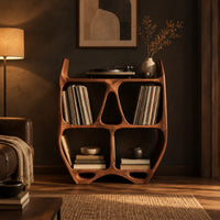Turntable stand shaped like a sculpted open shelf unit with two pointed tips in a dark living room at golden hour