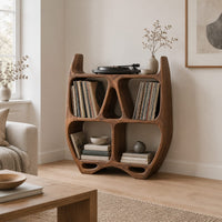 Turntable stand shaped like a sculpted open shelf unit with two pointed tips in a Scandinavian living room with white walls