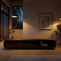 Low capsule TV console with a drawer box and open end in an evening room lit by two lamps