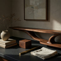 Corner detail of wall mounted TV shelf with branching arms beside wood, brass and linen samples