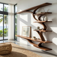 Wall mounted TV shelf with branching arms in a sunlit room with large windows and plants