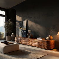 Low TV stand with wave carved door fronts in a living room at golden hour