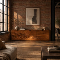 Low wooden tv stand with carved ocean wave and sun ray doors in an industrial loft living room with exposed brick