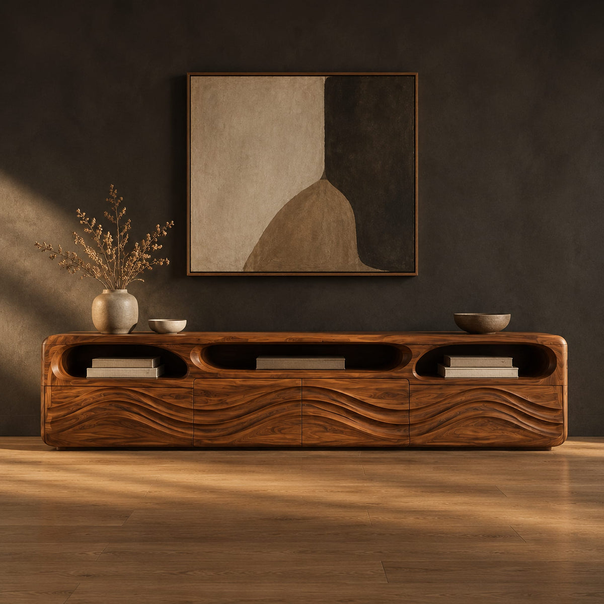 Low tv stand with carved wave relief on the front and open top cubbies in a dark studio against a charcoal plaster wall