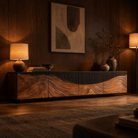 Low tv stand with carved flowing grain panels under a dark top band in an evening living room with walnut wall paneling
