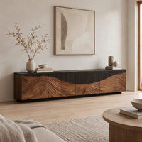 Low tv stand with carved flowing grain panels under a dark top band in a Scandinavian living room with white walls