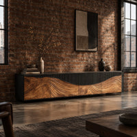 Low tv stand with carved flowing grain panels under a dark top band in an industrial loft living room with exposed brick