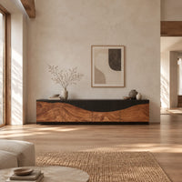 Low tv stand with carved flowing grain panels under a dark top band in a bright open plan living room