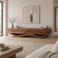 Low tv stand with a thick four panel body on a wavy ribbon base in a Scandinavian living room with white walls