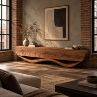 Low tv stand with a thick four panel body on a wavy ribbon base in an industrial loft living room with exposed brick