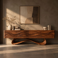 Corner detail of tv stand with four wave carved panels on a looping pedestal base beside wood, brass and linen samples