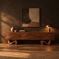 Tv stand with four wave carved panels on two twisting ribbon feet in a dark living room at golden hour