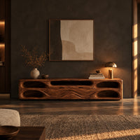 Long tv stand with pill shaped end niches and two center fronts in a dark living room at golden hour