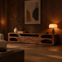 Long tv stand with pill shaped end niches and two center fronts in an evening living room with walnut wall paneling