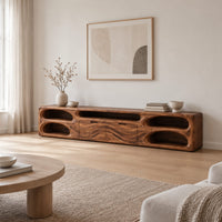 Long tv stand with pill shaped end niches and two center fronts in a Scandinavian living room with white walls
