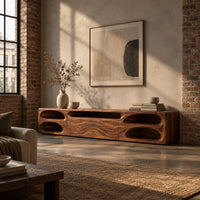 Long tv stand with pill shaped end niches and two center fronts in an industrial loft living room with exposed brick