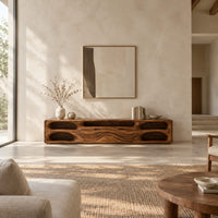 Long tv stand with pill shaped end niches and two center fronts in a bright open plan living room