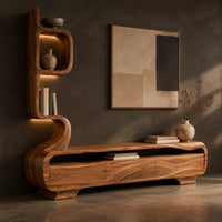 Corner detail of low media console with a tall sculpted display tower at one end beside wood, brass and linen samples