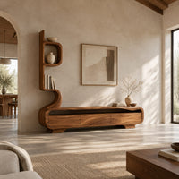 Low media console with a tall sculpted display tower at one end in a bright open plan living room