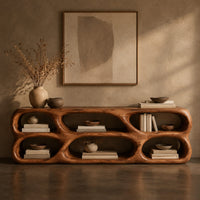 Corner detail of low wooden tv stand with two rows of sculpted open cells beside wood, brass and linen samples