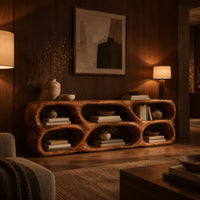Low wooden tv stand with two rows of sculpted open cells in an evening living room with walnut wall paneling