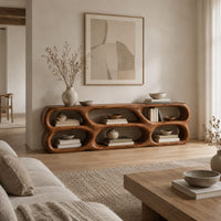 Low wooden tv stand with two rows of sculpted open cells in a Scandinavian living room with white walls