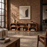 Low wooden tv stand with two rows of sculpted open cells in an industrial loft living room with exposed brick