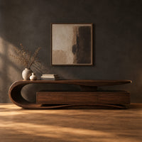 Tv stand with a sweeping loop end and low three panel cabinet in a dark studio against a charcoal plaster wall