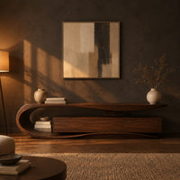Tv stand with a sweeping loop end and low three panel cabinet in a dark living room at golden hour