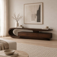 Tv stand with a sweeping loop end and low three panel cabinet in a Scandinavian living room with white walls