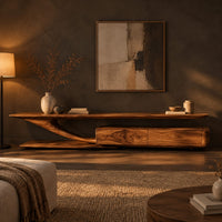 Tv stand with a sweeping plank top and a low two panel cabinet block in a dark living room at golden hour