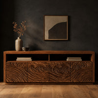 Tv stand with four swirl carved door fronts and two open top bays in a dark studio against a charcoal plaster wall