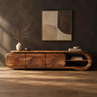 Tv stand with three wave carved fronts and an open looped end shelf in a dark studio against a charcoal plaster wall