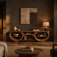 Tv stand with two large oval openings, open shelves and carved organic edges in a dark living room at golden hour