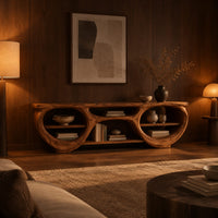 Tv stand with two large oval openings, open shelves and carved organic edges in an evening living room with walnut wall paneling