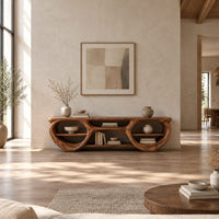 Tv stand with two large oval openings, open shelves and carved organic edges in a bright open plan living room