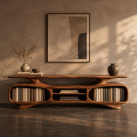 Corner detail of low tv stand with two oval bays, a center shelf and sculpted feet beside wood, brass and linen samples