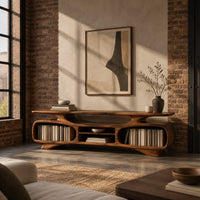 Low tv stand with two oval bays, a center shelf and sculpted feet in an industrial loft living room with exposed brick