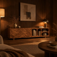Low tv stand with wave carved fronts and open pill shaped cubbies in an evening living room with walnut wall paneling
