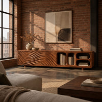 Low tv stand with wave carved fronts and open pill shaped cubbies in an industrial loft living room with exposed brick