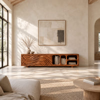 Low tv stand with wave carved fronts and open pill shaped cubbies in a bright open plan living room