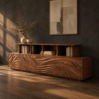 Tv stand with wave carved front panels and a raised open display shelf, three-quarter view showing the grain