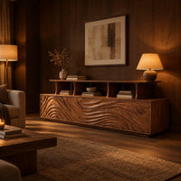 Tv stand with wave carved front panels and a raised open display shelf in an evening living room with walnut wall paneling
