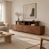 Tv stand with wave carved front panels and a raised open display shelf in a Scandinavian living room with white walls