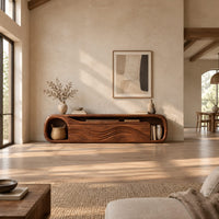 Capsule shaped tv stand with wave relief fronts and an open end niche in a bright open plan living room