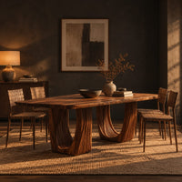 Rectangular dining table with a slab top and twin fluted arch pedestals in a dark dining room at golden hour