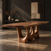 Dining table with a natural edge slab top and two sculpted arch legs, three-quarter view showing the grain