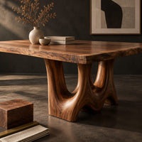 Corner detail of dining table with a natural edge slab top and two sculpted arch legs beside wood, brass and linen samples