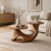 Coffee table with two disc tops at different heights on a swooping base in a Scandinavian living room with white walls